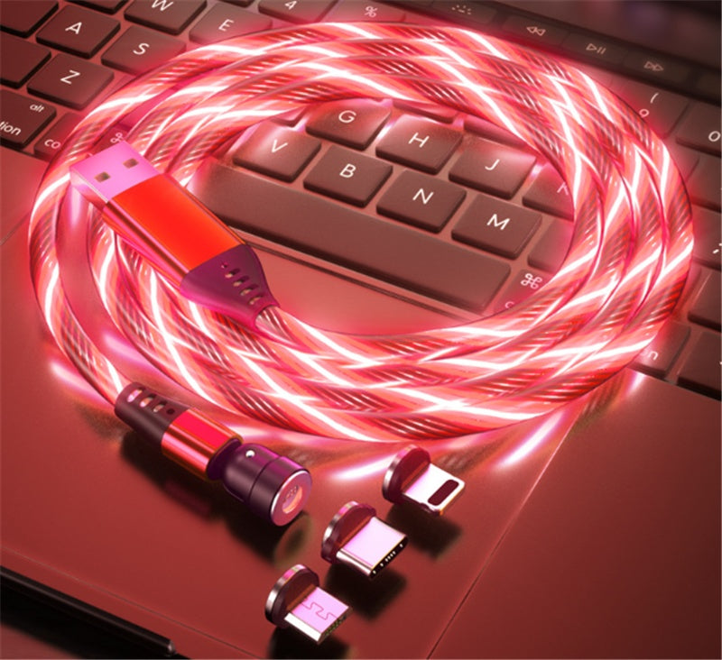 Red luminous magnetic USB charging cable with three interchangeable magnetic connectors on laptop keyboard