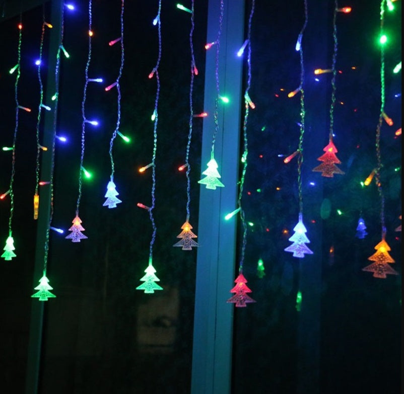 Colorful LED Christmas tree icicle lights hanging on window, multicolor festive decoration