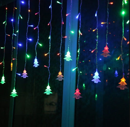 Colorful LED Christmas tree icicle lights hanging on window, multicolor festive decoration
