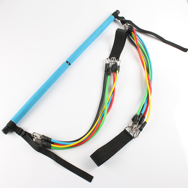 Blue Pilates bar with colorful resistance bands and black straps for home workout