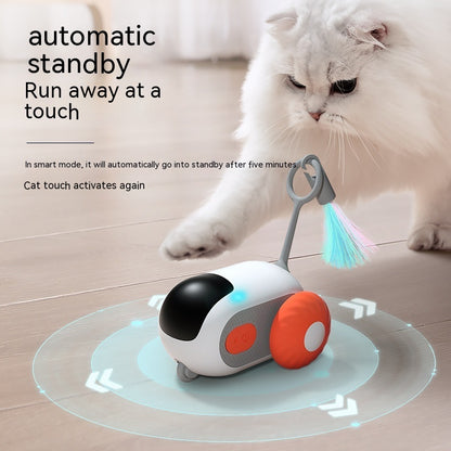 white fluffy cat pawing at blue and white interactive remote control car toy with orange wheels and colorful feather