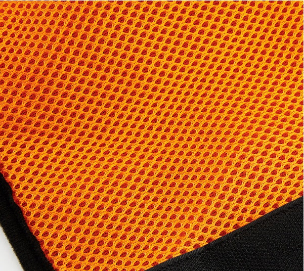 Close-up of orange breathable mesh fabric with black trim on a dog harness
