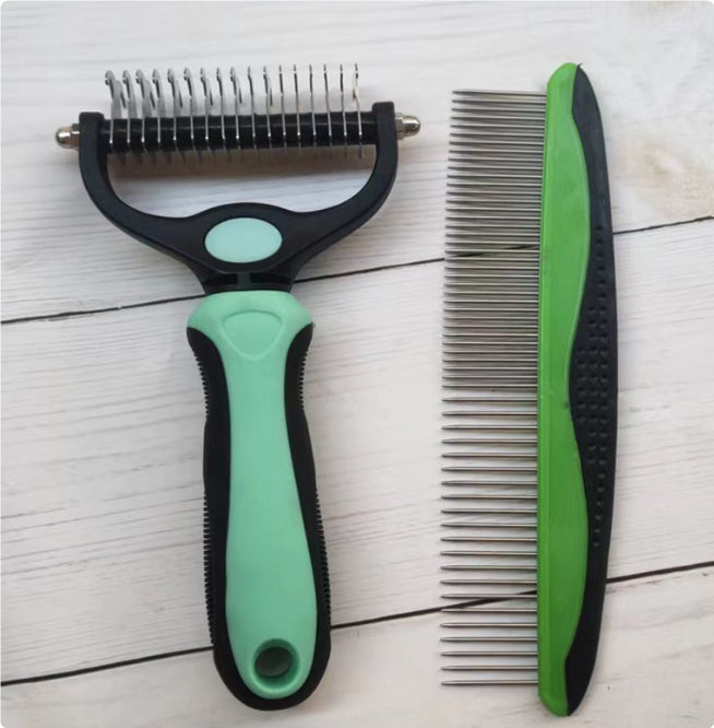 Double-sided stainless steel pet grooming comb and green-handled steel pet comb on white wooden surface