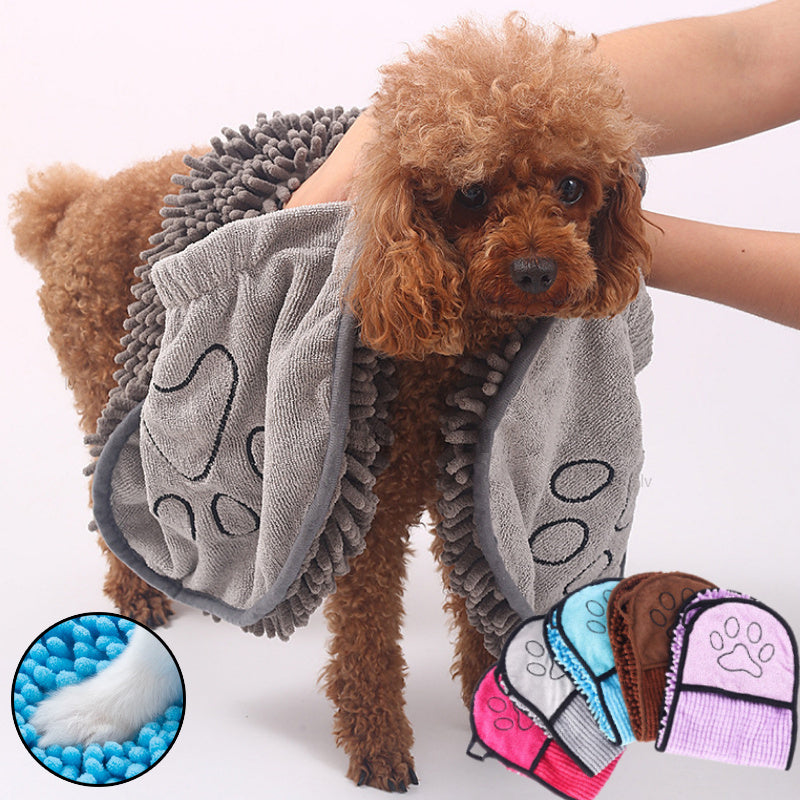 Curly brown dog wrapped in gray super absorbent microfiber pet towel with paw print design
