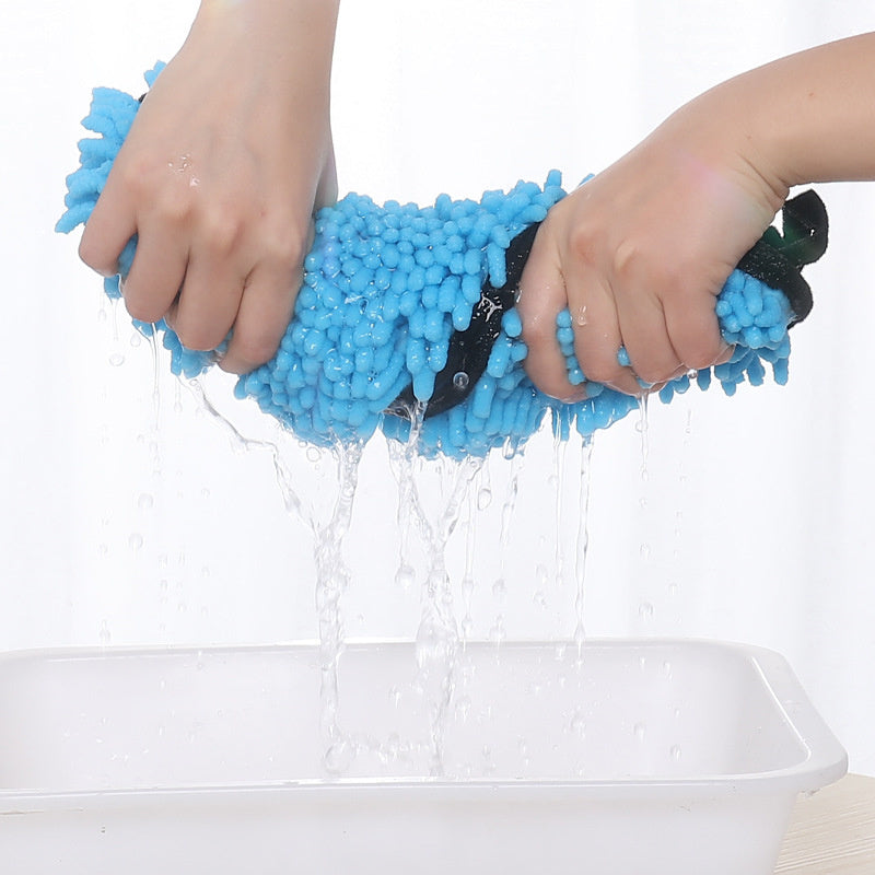 Hands wringing out a blue super absorbent microfiber pet towel over a white basin