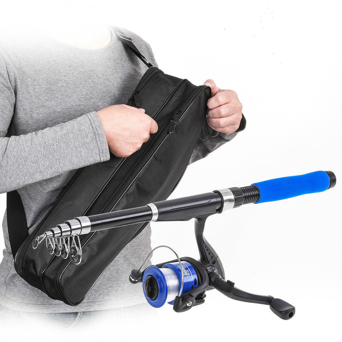 Person holding black fishing rod bag and blue telescopic fishing rod with reel on white background