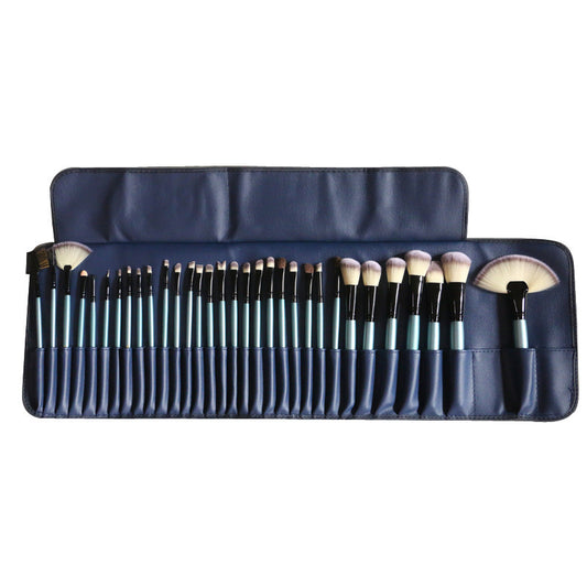 32-piece blue makeup brush set with light blue handles and black ferrules in navy blue roll-up case