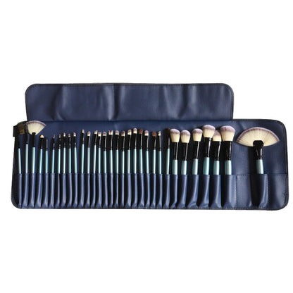 32-piece blue makeup brush set with synthetic fibers in navy blue roll-up case
