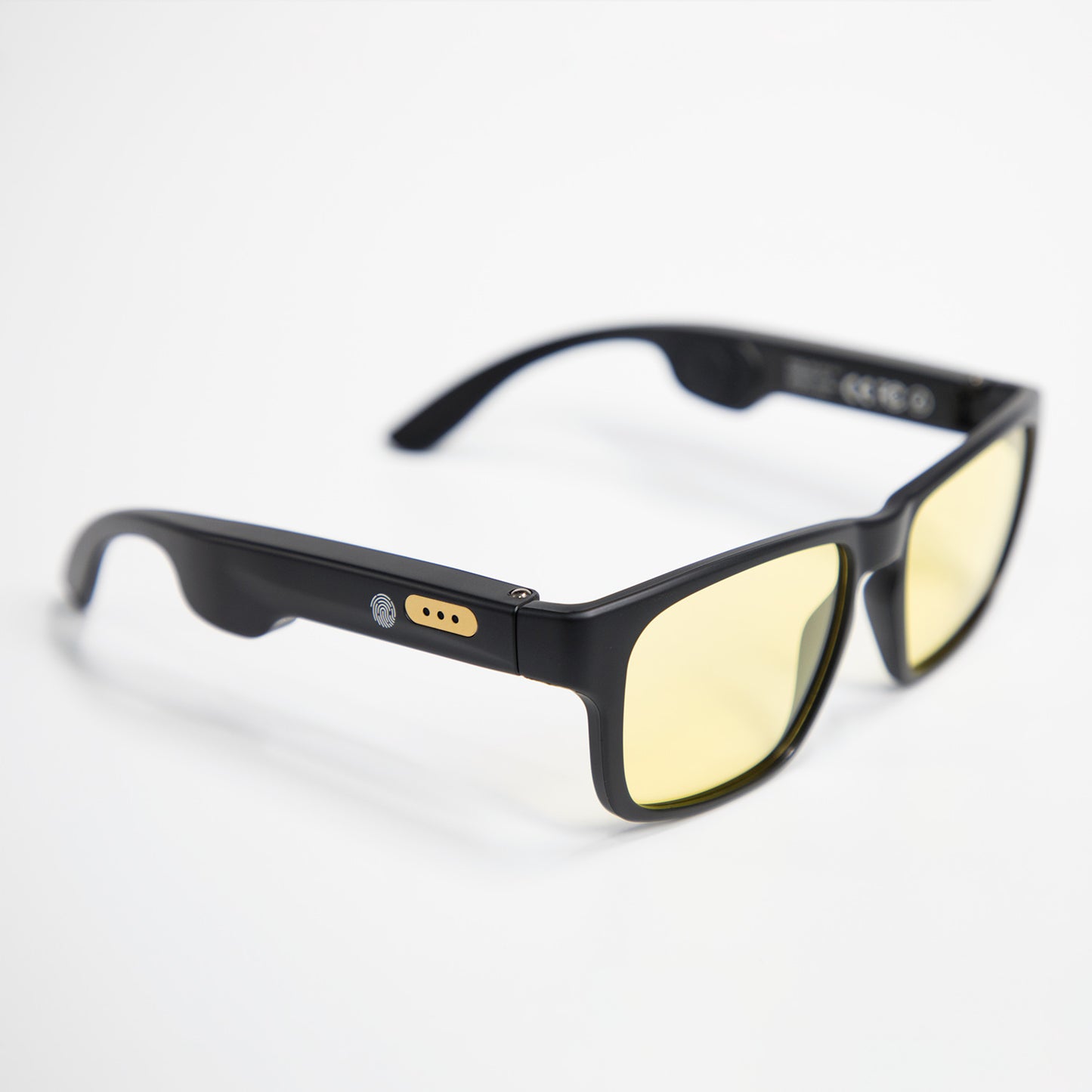 Black smart sunglasses with yellow tinted lenses and fingerprint sensor on the temple