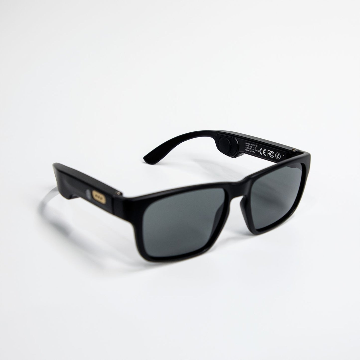 Black smart Bluetooth sunglasses with rectangular dark lenses on white background