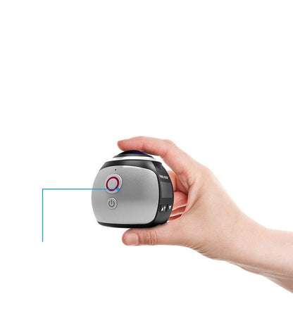 Hand holding compact digital 5MP VR camera with power button and lens on top