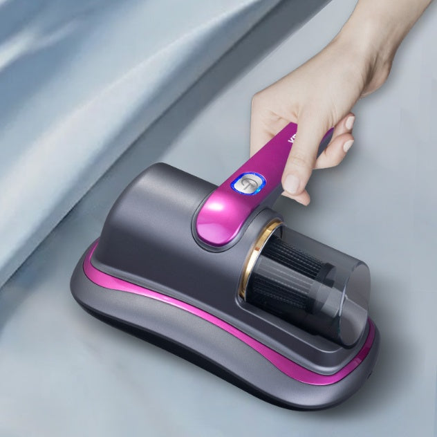 Hand holding Trendoligy wireless mite vacuum cleaner with UV sterilization on fabric surface, gray and purple device