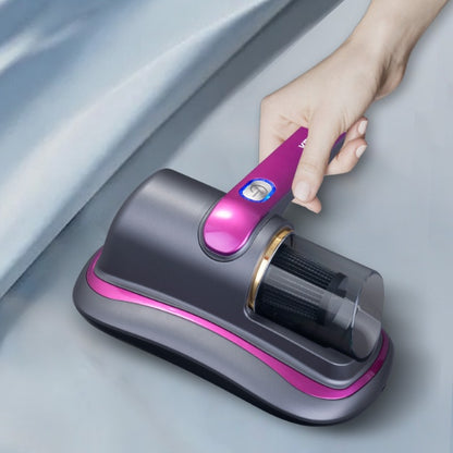 Hand holding Trendoligy wireless mite vacuum cleaner with UV sterilization on fabric surface, gray and purple device