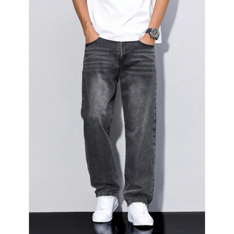 Men's black washed straight leg jeans with loose fit, paired with white sneakers and white t-shirt