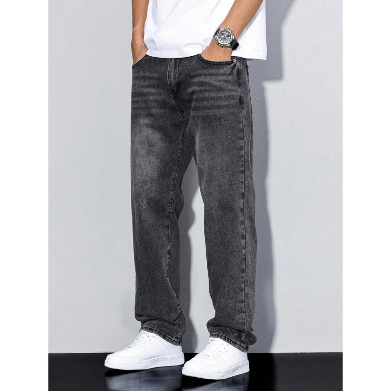 Men's black washed straight leg jeans with loose fit, paired with white sneakers and white t-shirt