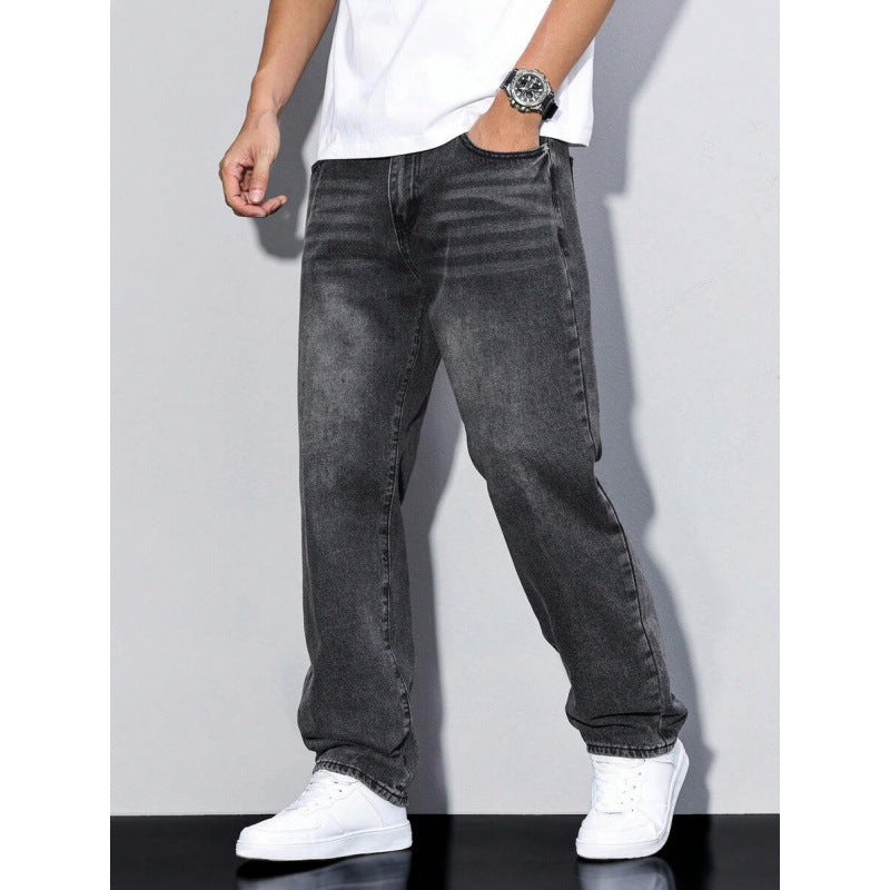Men's black washed straight leg jeans with loose fit paired with white sneakers and a white t-shirt