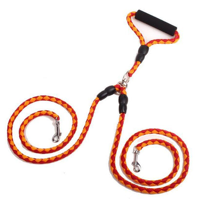 Double dog leash in orange and yellow braided rope with padded foam handle and metal clips