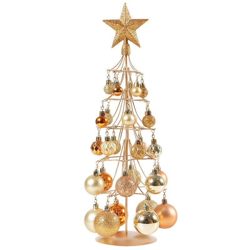 Modern bronze gold metal Christmas tree with assorted metallic and glitter ornaments topped with a glittery star