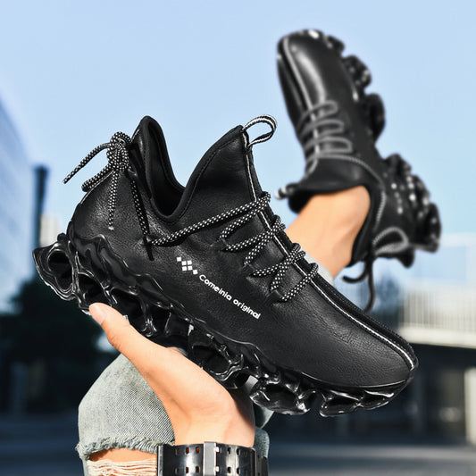 Black Comeinia Original sneakers with futuristic sole and patterned laces held outdoors