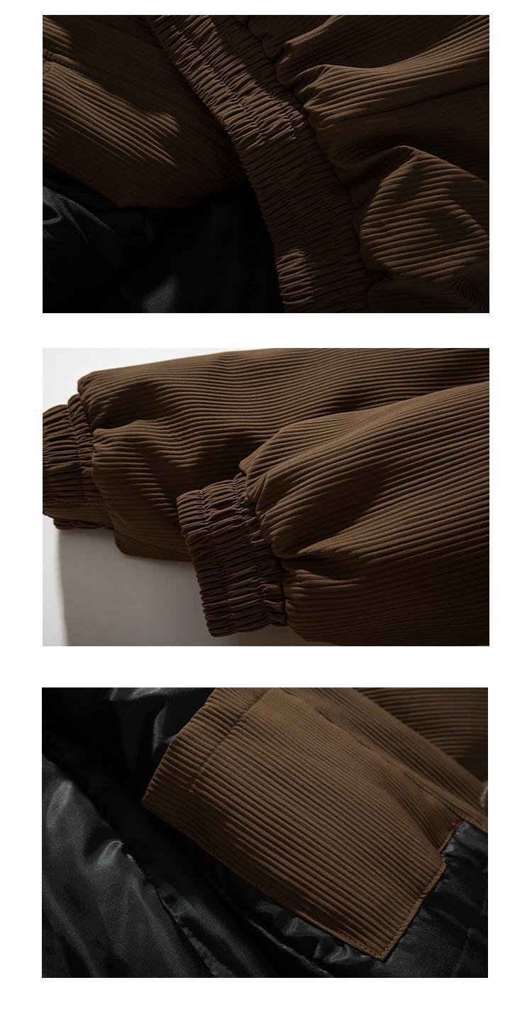 Close-up details of brown padded cotton jacket showing ribbed fabric, elastic cuffs, and black lining