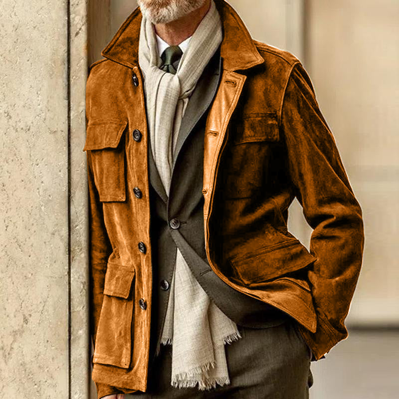Man wearing brown suede casual jacket with lapel collar and patch pockets over a suit and scarf