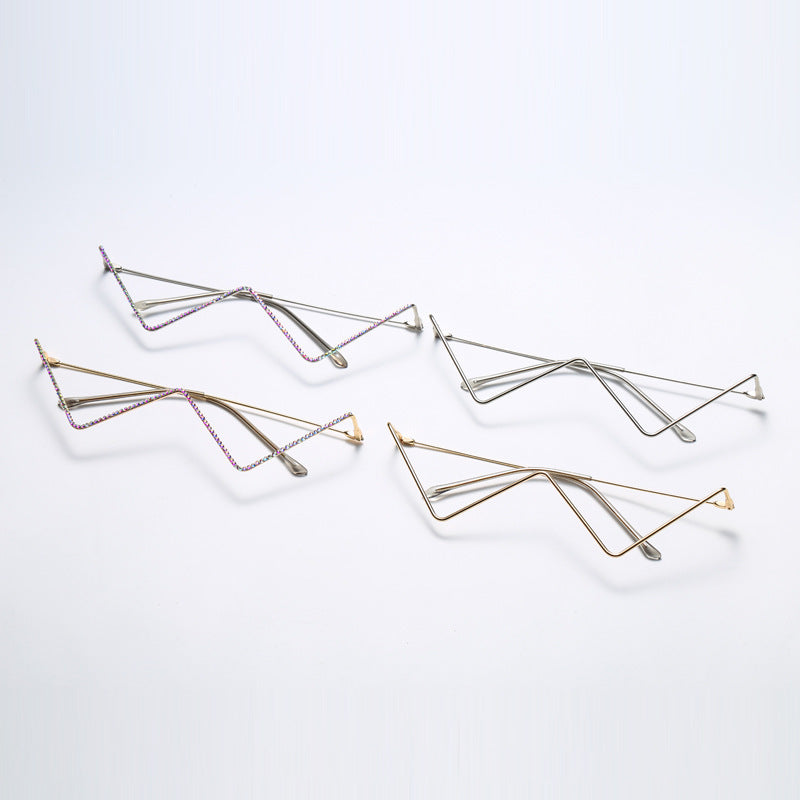 Set of four half-frame metal glasses in gold and silver with zigzag decorative design on white background