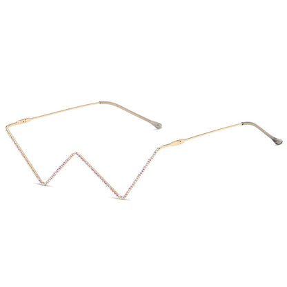 Gold metal half-frame glasses with distinctive zigzag design and rhinestone decoration