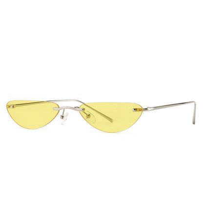 Slim metal frame cat-eye sunglasses with narrow yellow tinted lenses on white background