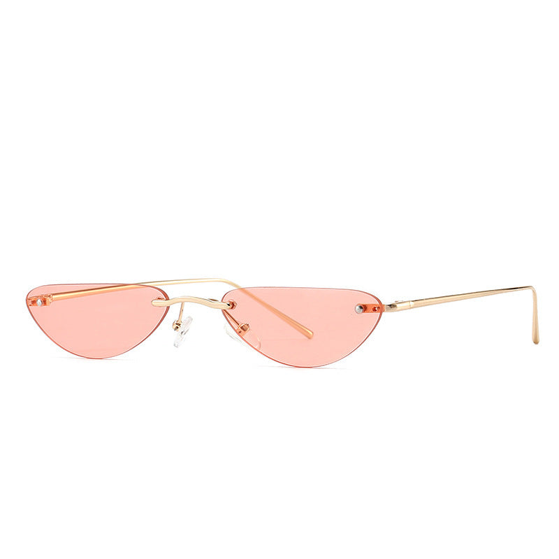 Slim cat eye sunglasses with narrow pink tinted lenses and gold metal alloy frame