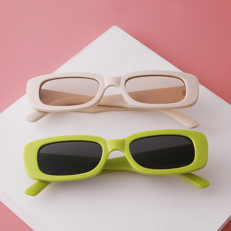 Two rectangular fashion sunglasses with UV protection, one beige with light brown lenses and one lime green with dark lenses