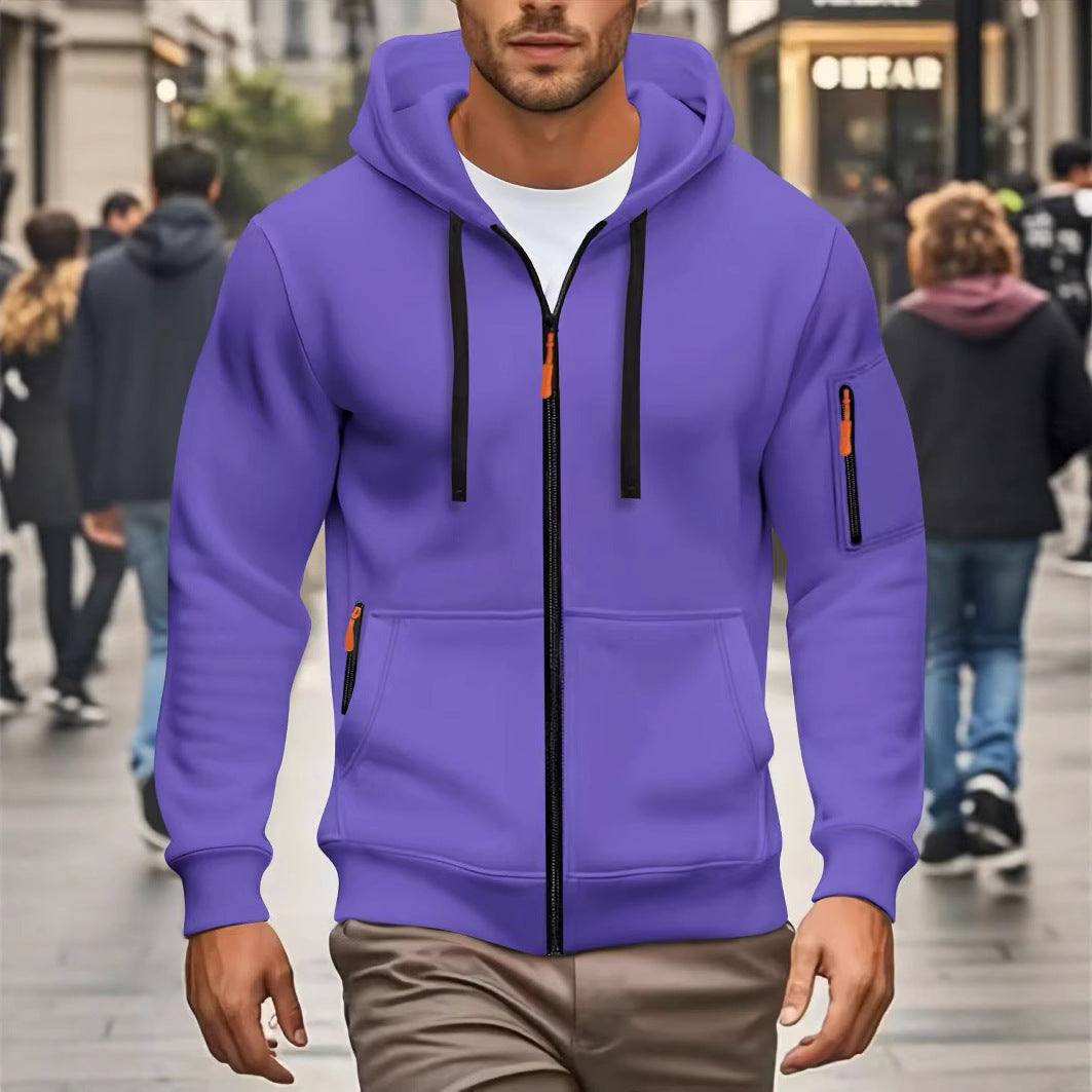Man wearing purple zip-up hoodie with black drawstrings and zippers walking in urban street