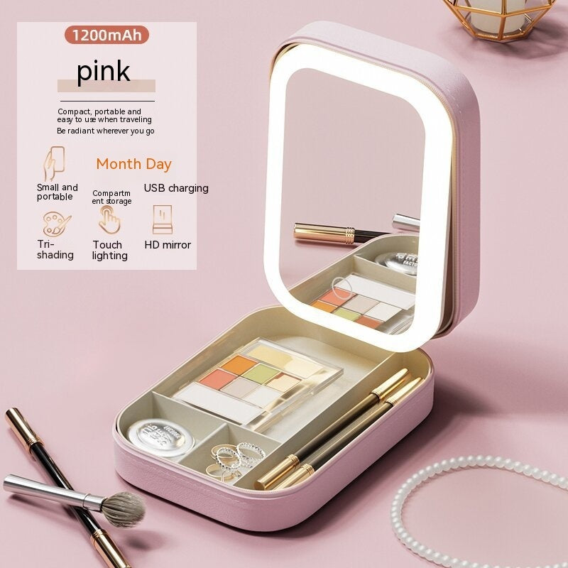 Pink portable LED makeup storage box with adjustable lighted mirror, eyeshadow palette, brushes, and jewelry