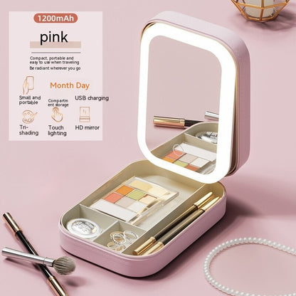 Pink portable LED makeup storage box with adjustable lighted mirror, eyeshadow palette, brushes, and jewelry