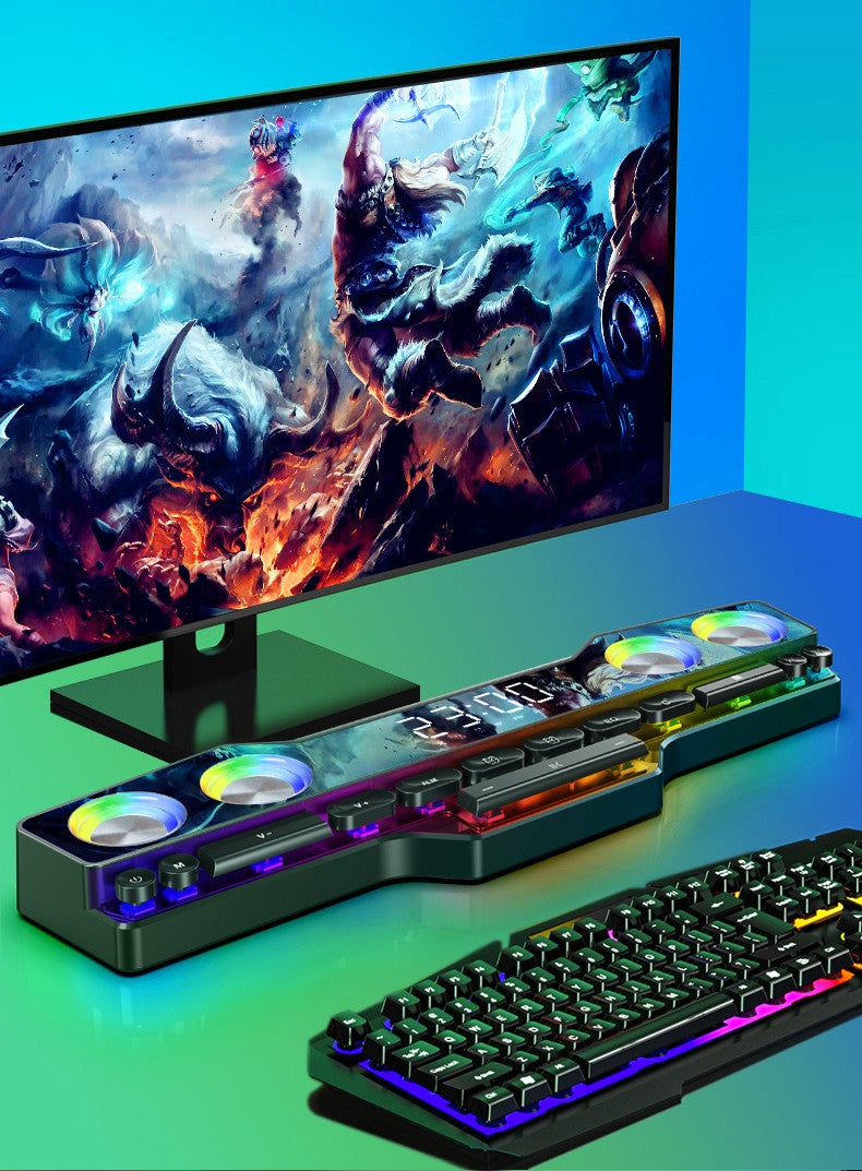 Gaming setup with RGB mechanical keyboard, RGB speaker with fans and digital display, and monitor showing fantasy battle artwork