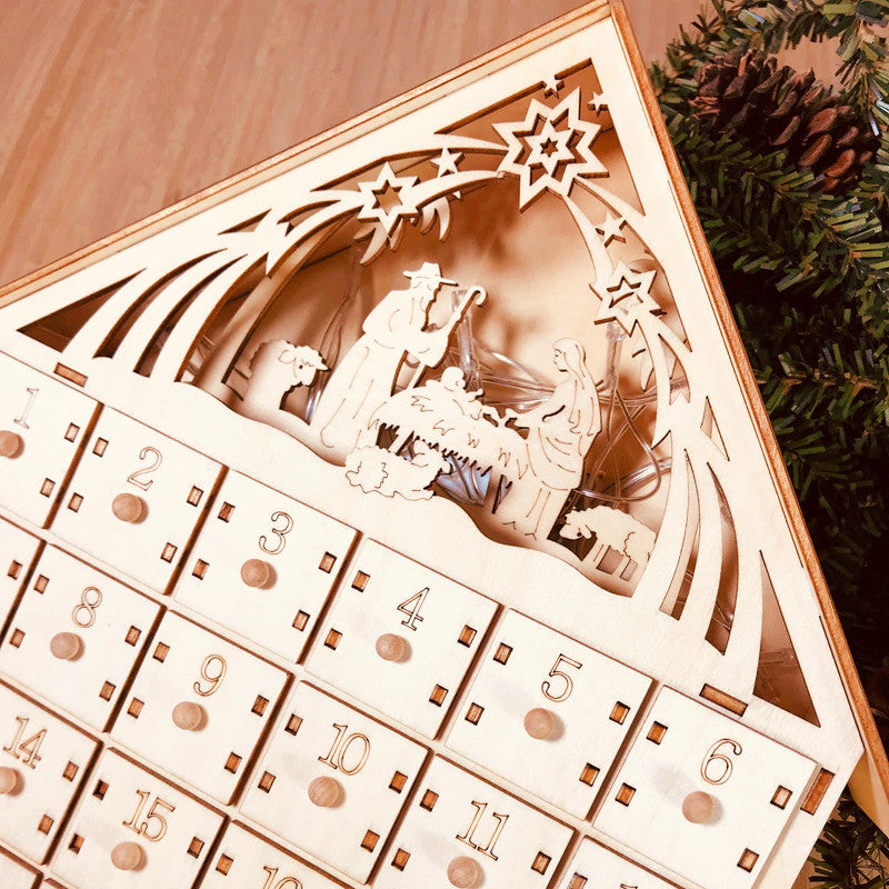 Wooden Christmas advent calendar featuring Nativity scene with baby Jesus, Mary, Joseph, and stars
