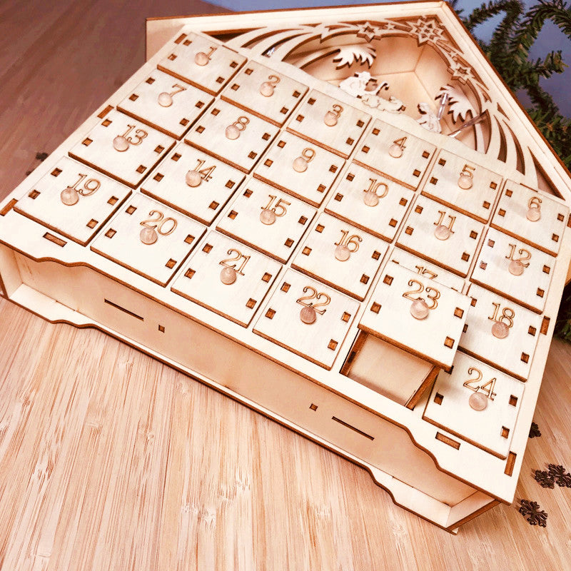 DIY wooden Christmas advent calendar with 24 numbered drawers and nativity scene cutout