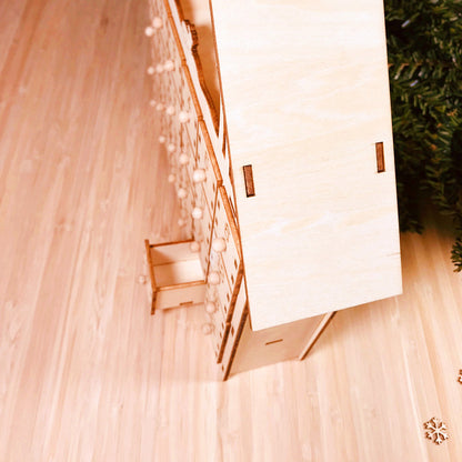 DIY wooden Christmas advent calendar with numbered drawers and holiday countdown design on a wooden surface