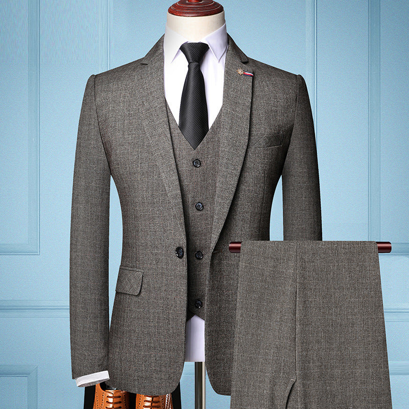 Men's three-piece coffee brown suit with black tie and white shirt on mannequin