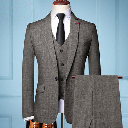 Men's three-piece coffee brown suit with vest, white shirt, black tie on mannequin, formal business attire