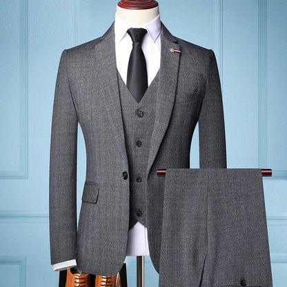 Gray men's three-piece formal suit with black tie, white shirt, and matching trousers on mannequin