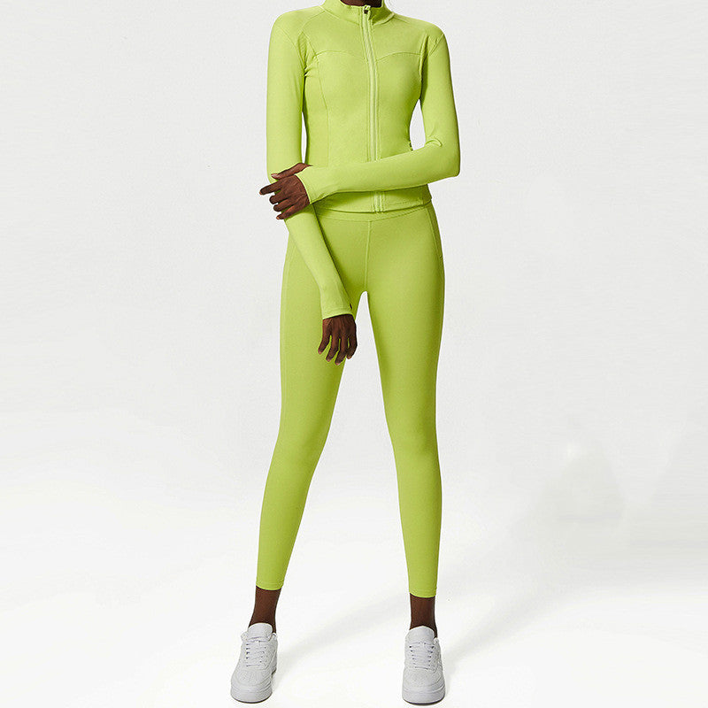 woman wearing neon green two-piece activewear set with long-sleeve zip-up top and leggings, white sneakers