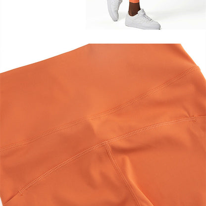 Close-up of orange nylon blend activewear leggings with visible flatlock stitching detail