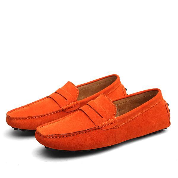Pair of bright orange suede men's driving loafers with stitched details and rubber pebble soles