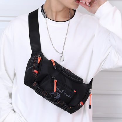 black nylon waterproof men's crossbody messenger bag with orange zipper pulls worn over white sweatshirt