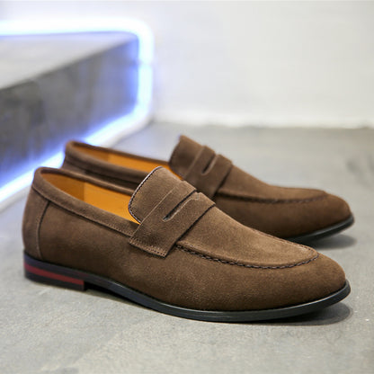 Dark brown men's nubuck slip-on loafers with rubber sole on gray floor