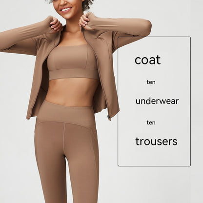 Smiling woman in nude feel brown sports bra, coat, and high-waisted trousers activewear set