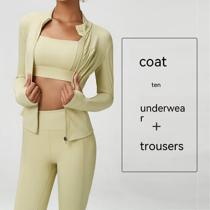 woman in light beige three-piece athletic activewear set with jacket, bra top, and high-waisted leggings