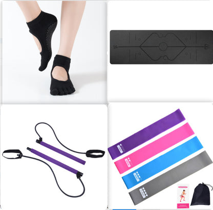 Non-slip black yoga mat with position lines, toe socks with grips, resistance bands, and loop bands set