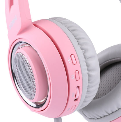 Close-up of pink gaming headset with cat ear design, padded ear cushion, and volume controls