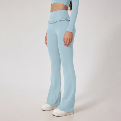 woman wearing light blue high waist flare yoga pants with ruffle detail and matching crop top
